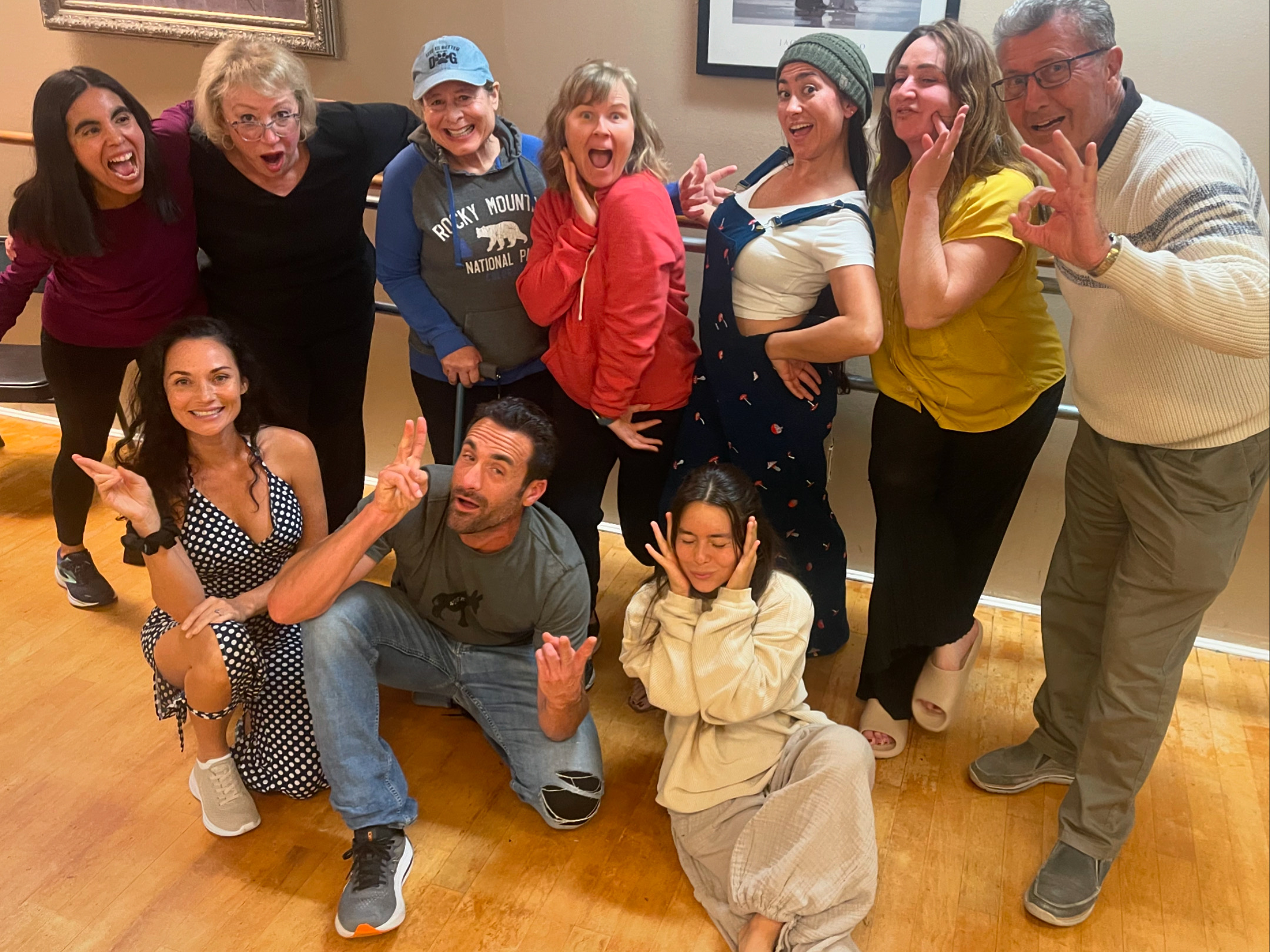 A diverse group of workshop participants laughing together